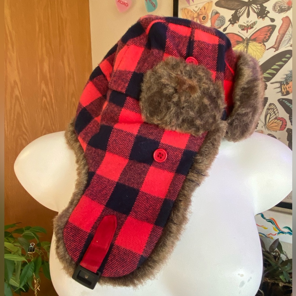 Red and black plaid winter hat with faux fur trim